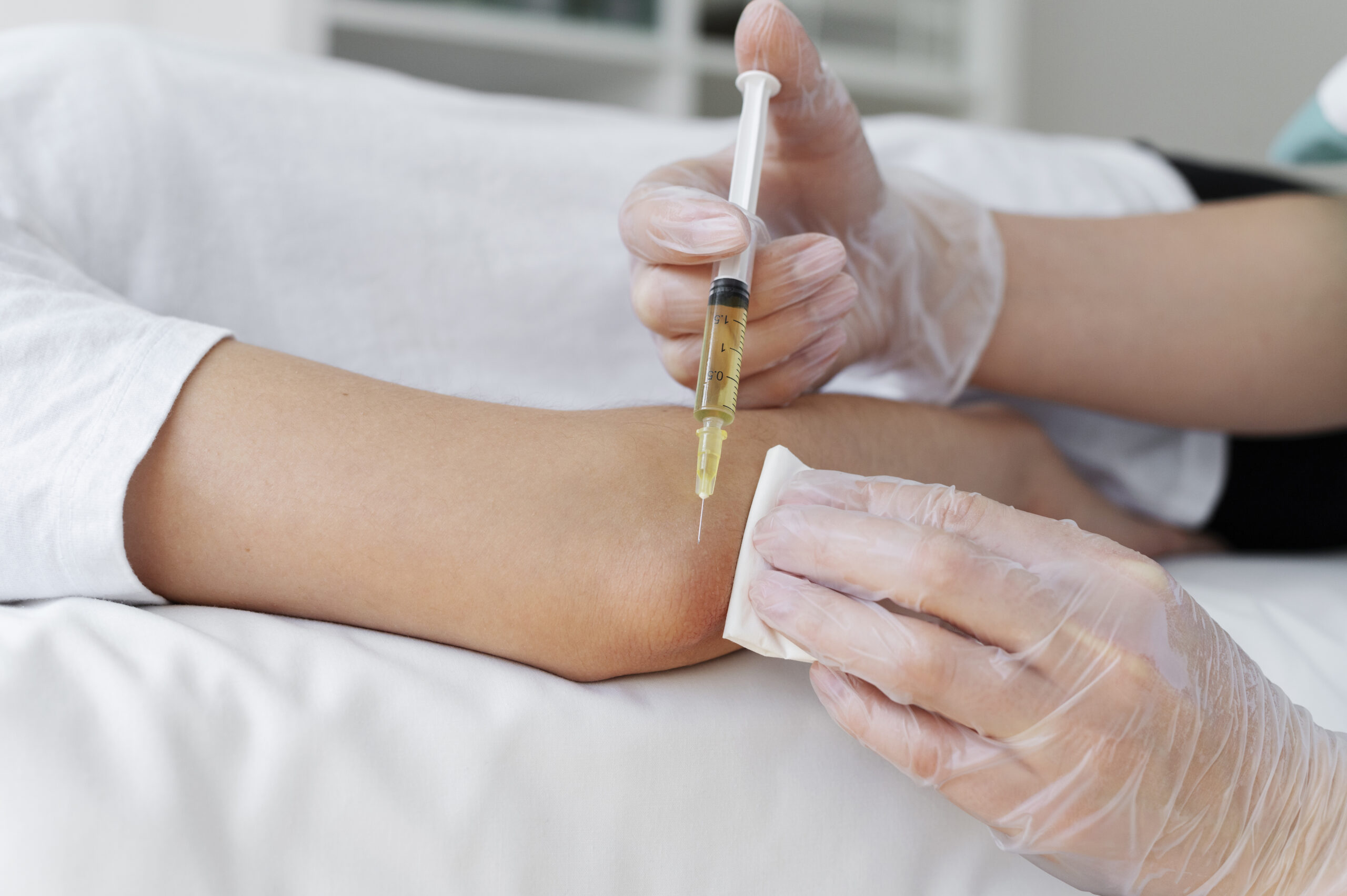high-angle-patient-getting-elbow-prp-treatment iv drip for hair care